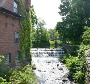 A brook flows from Railroad Pond, just outside the Milford Oval, and under the bridge leading to Elm Street.