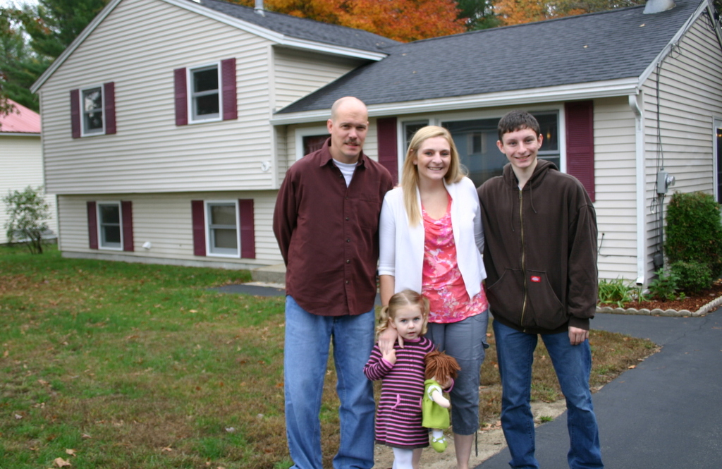 Happy new owners: The Cook-Coulon family were excited to settle into their new home in Milford, with the help of Liz Bruce, of Apple Orchard Realty.